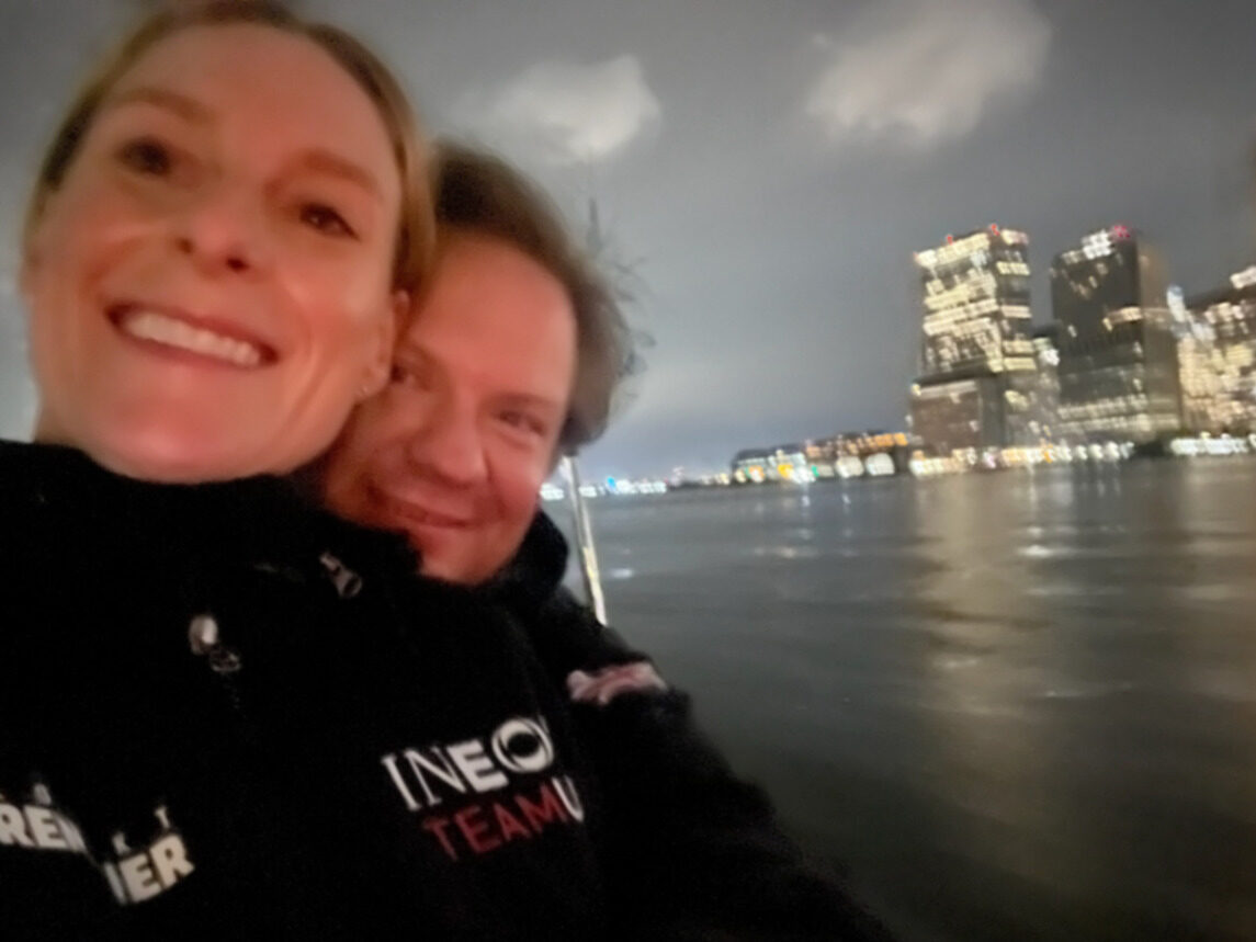Phoebe and Chris on the water at night