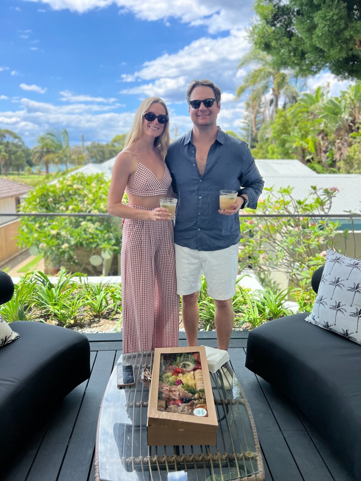 Phoebe and Chris with drinks on a sunny terrace